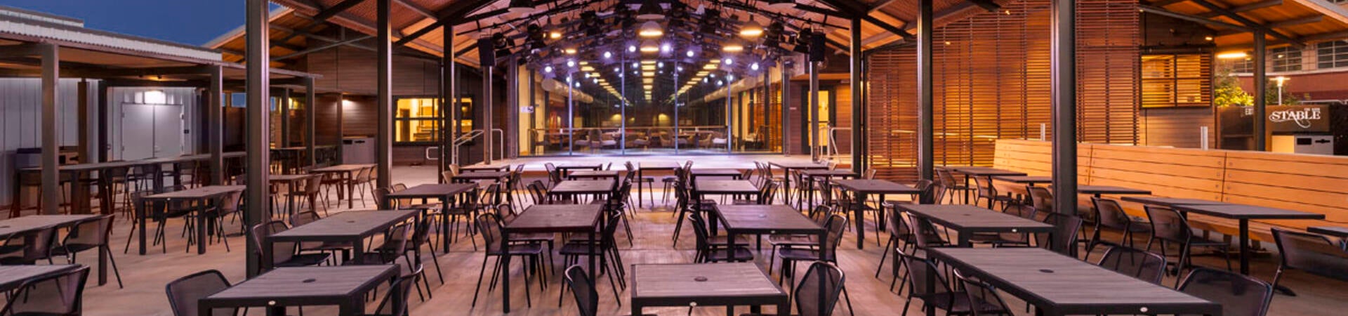 Exterior of the Barn and Stable patio at dusk.